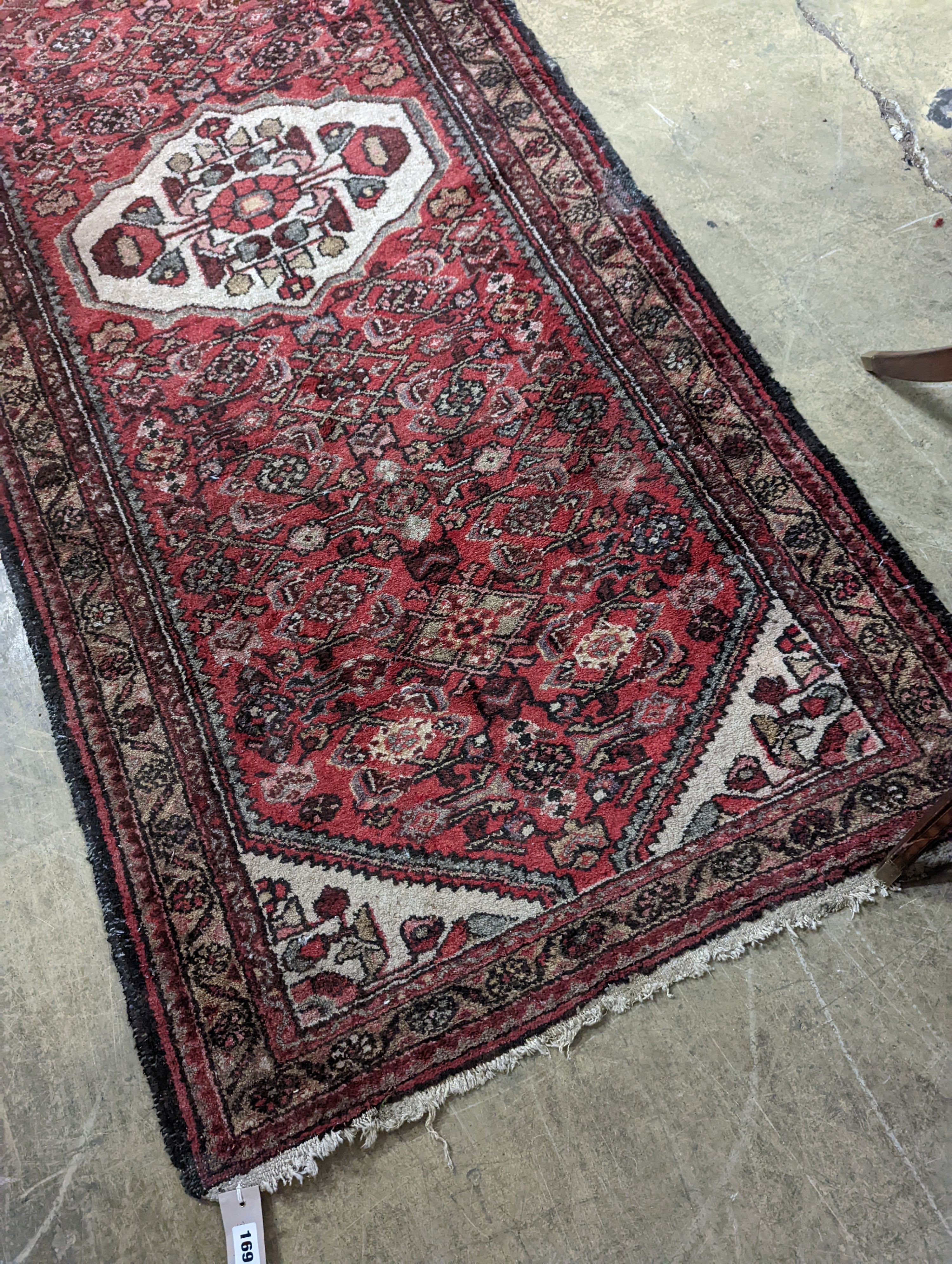 A Hamadan red ground rug, 190 x 82cm